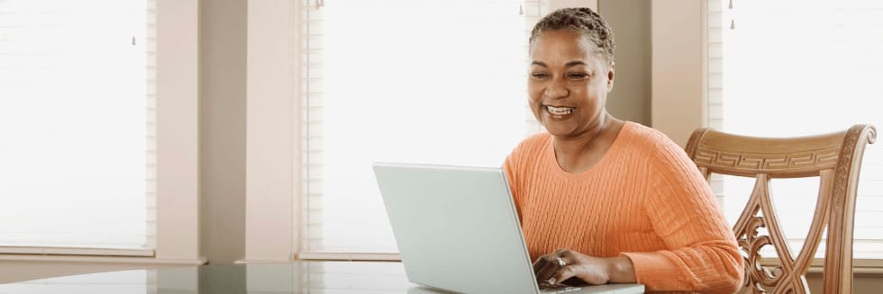 Learner studies for a certificate program on a laptop.