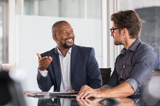 Team members use business communication skills during a meeting.